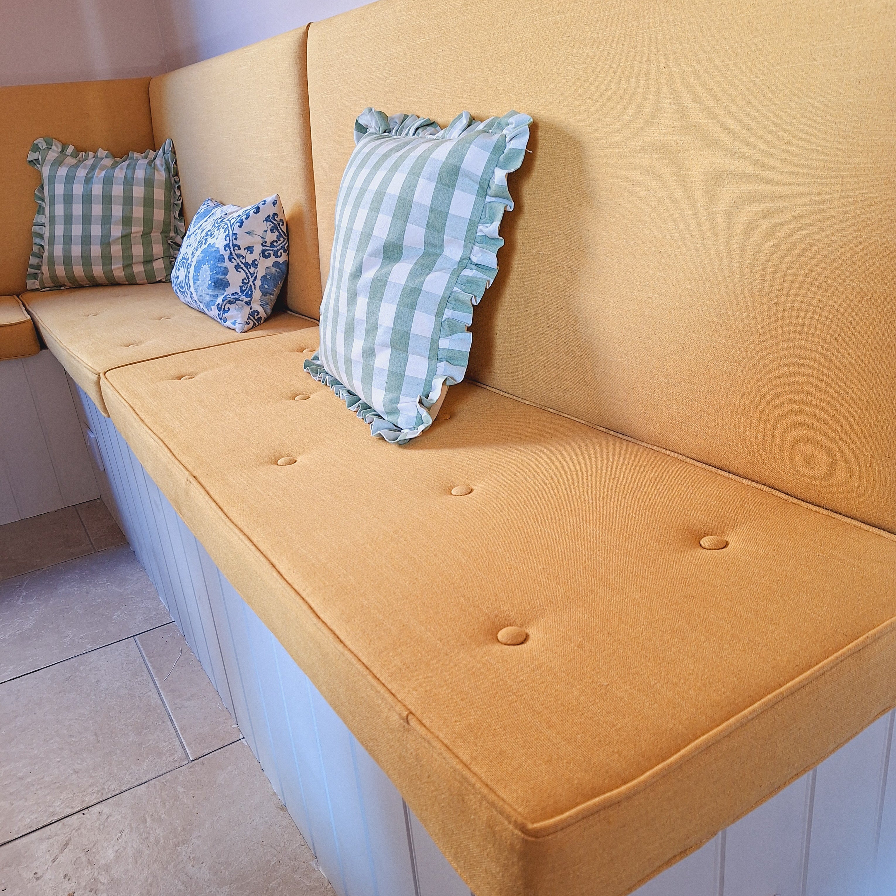 Ochre buttoned and piped bench cushion
