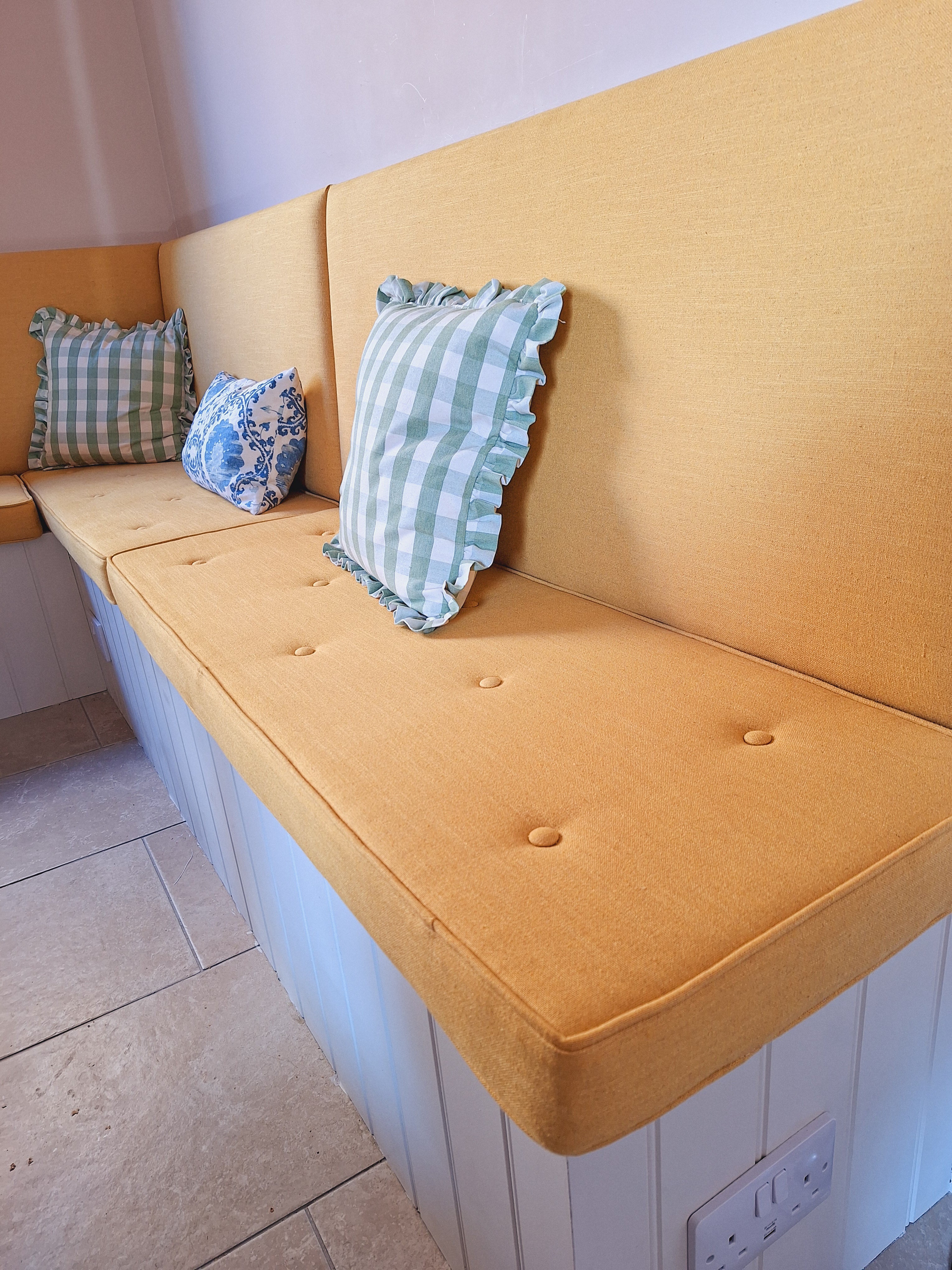 Ochre buttoned and piped bench cushion