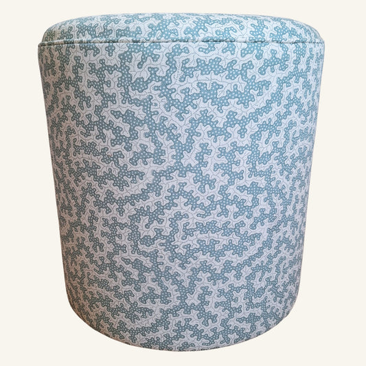 Cylindrical stool with a blue white organic pattern on a white background