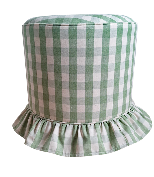 A cylindrical upholstered stool or ottoman with a green and white gingham check pattern and a ruffled skirt base, shown on a plain white background.