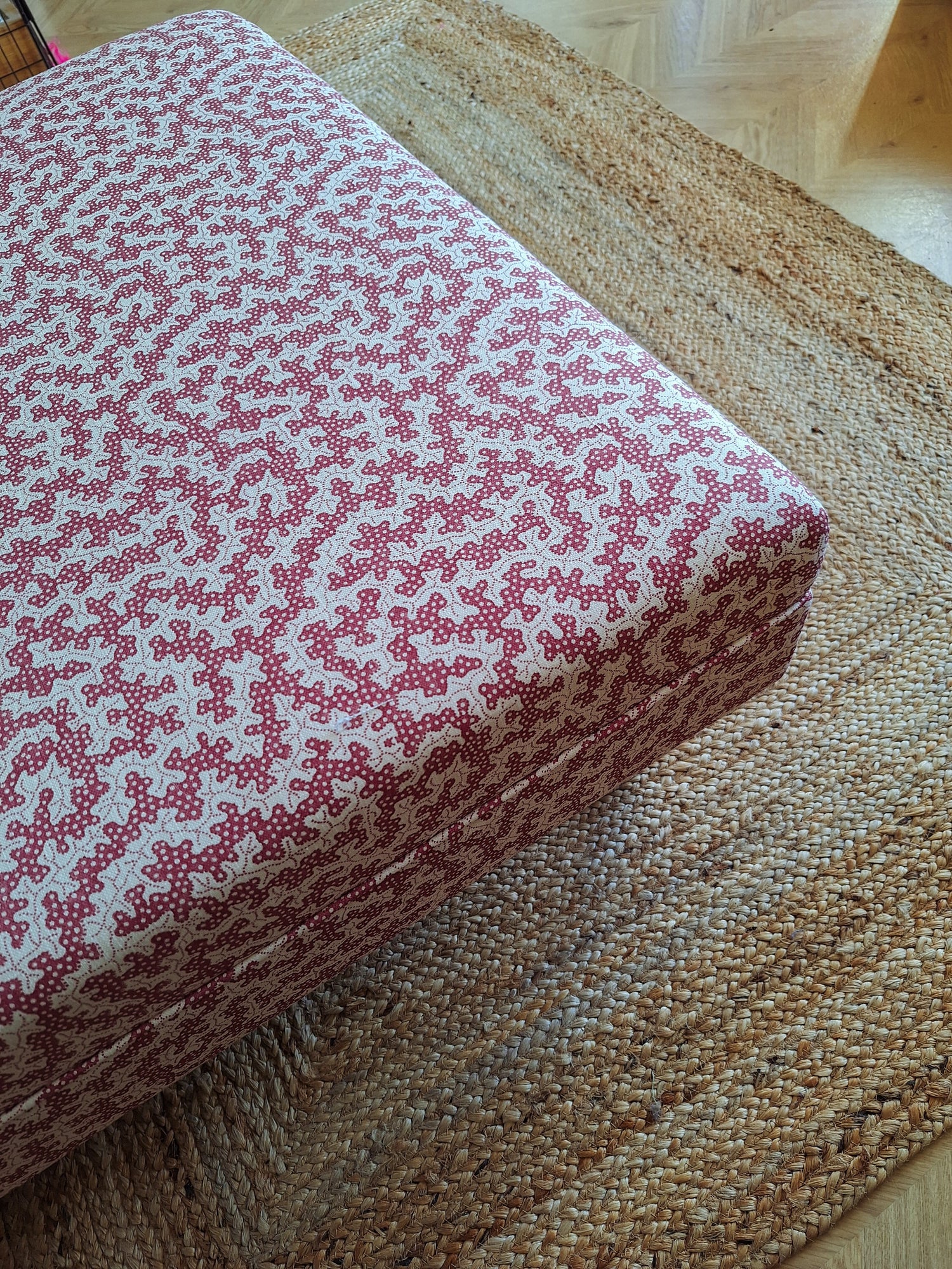 Custom upholstered ottoman in patterned Sanderson truffle fabric by North End Interiors