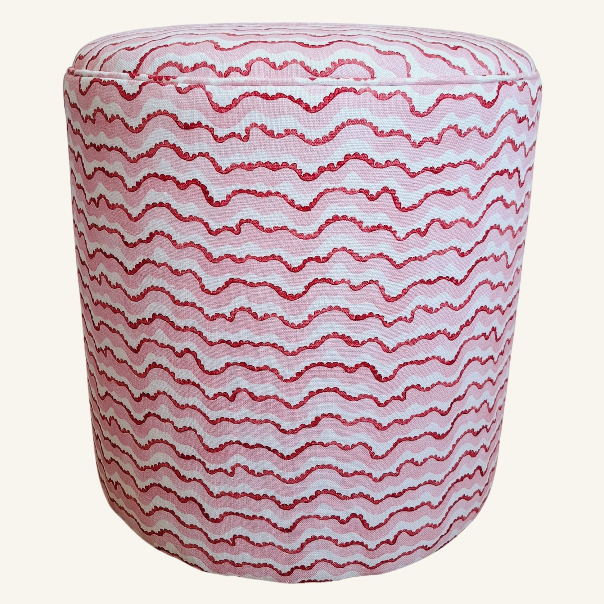 Round ottoman with red wavy pattern on a white background